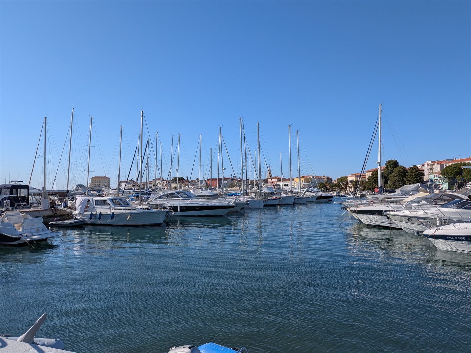 Poreč marina with sailboats and the old town behind, last morning in Croatia