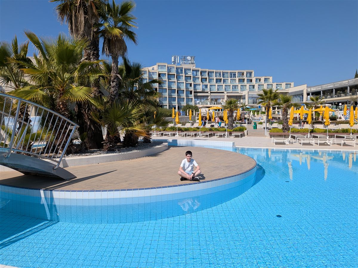Sitting by the hotel pool after arrival in Poreč