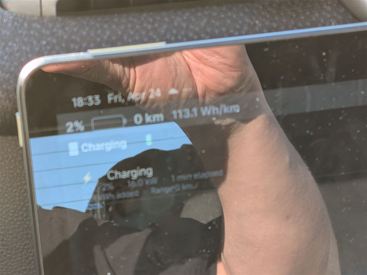 evOS screen showing 2% battery remaining and charging notification